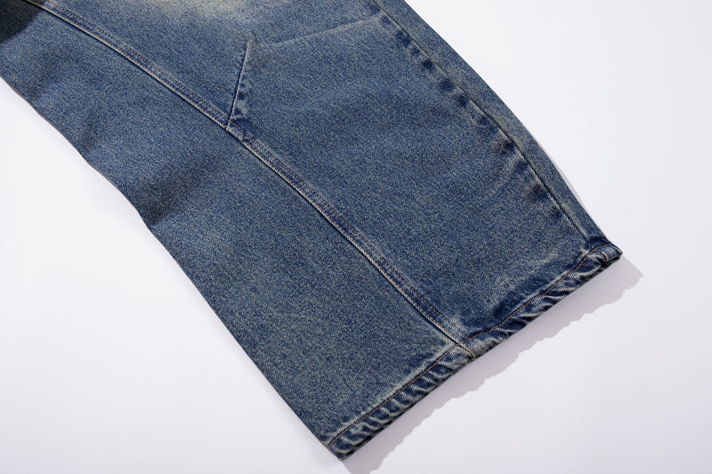 Close-up of another denim hem on faded blue wide-leg jeans