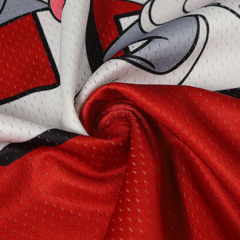 Close-up of a red and white Bugs Bunny football jersey fabric with printed cartoon graphic and mesh texture