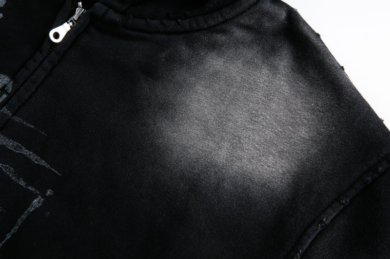 Close-up of washed black hoodie chest fabric and zipper area