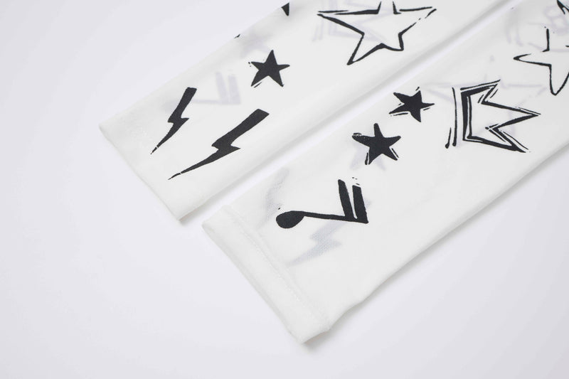 Close-up of white sleeve cuff with black lightning bolt and star print