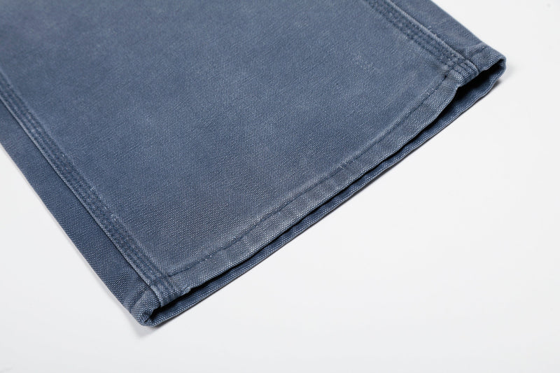 Close-up of hem on blue wide-leg denim jeans