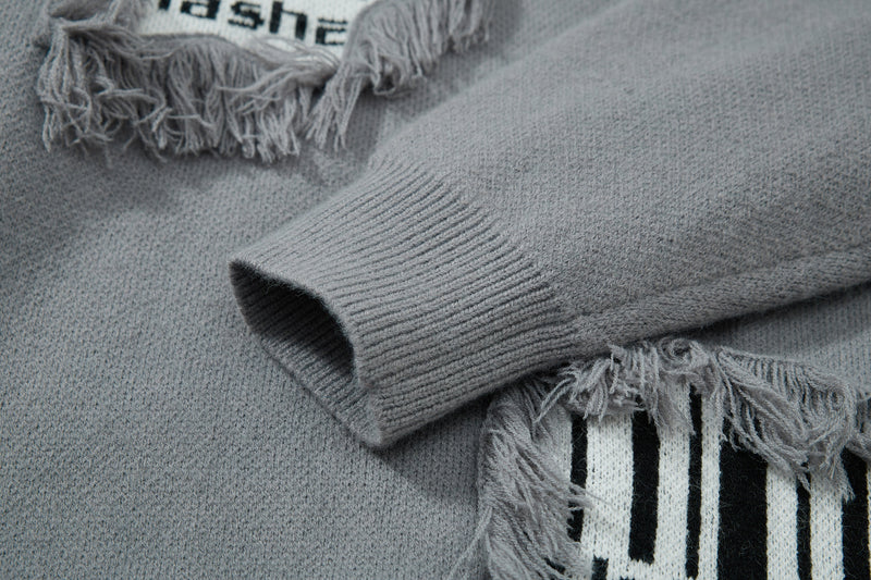 Gray knit sweater close-up of sleeve cuff and chest patch details