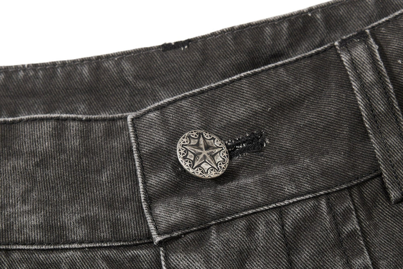 Dark charcoal denim waistband close-up with star button and stitching