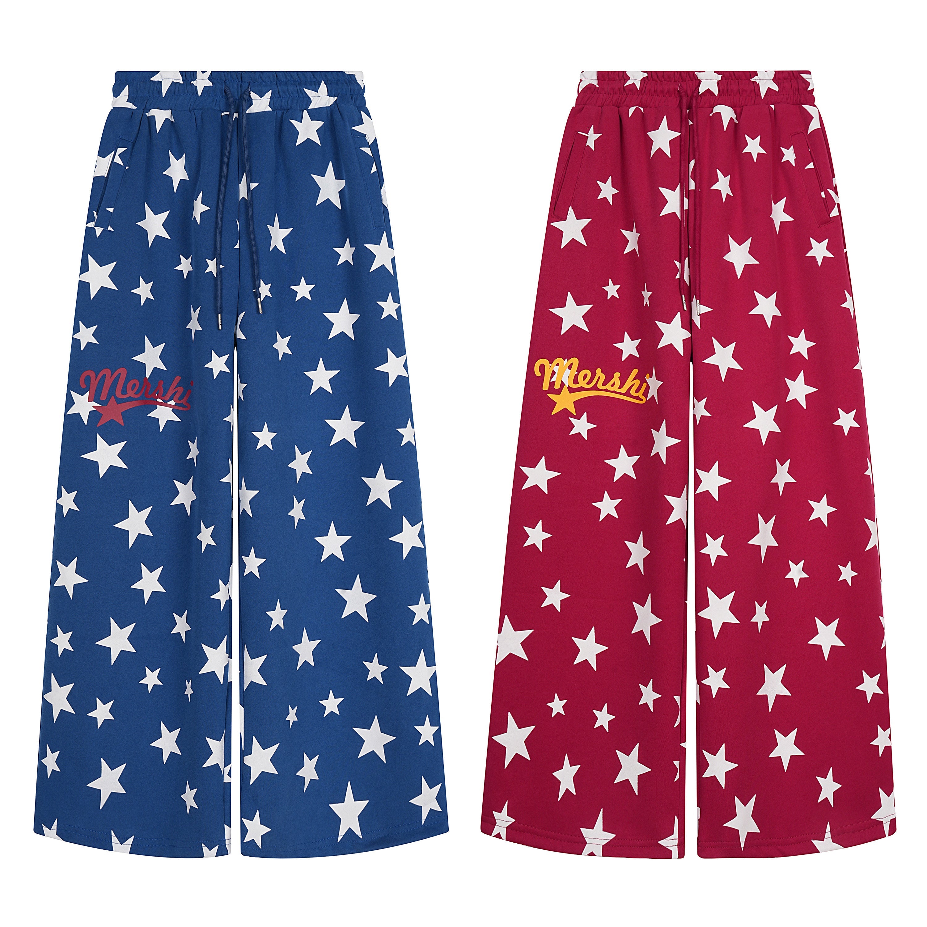 Royal blue wide-leg sweatpants with all-over white star print, drawstring waist, and red script logo graphic on left thigh