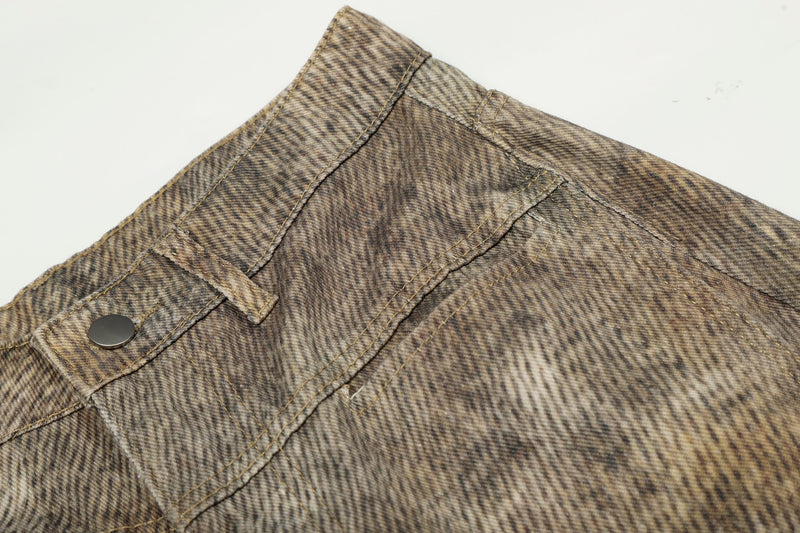 Close-up of back waistband button and seam details on leopard wash jeans