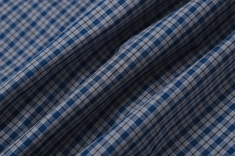 Close-up of blue and gray plaid fabric folds with fine check pattern