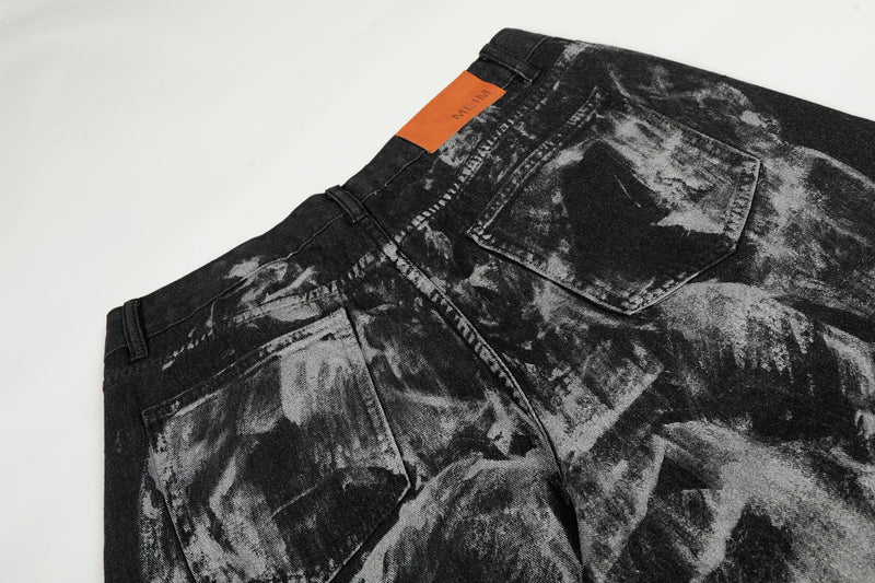 Close-up of back waistband and pocket on black painted jeans with orange patch