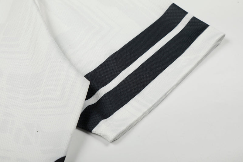 White mesh soccer jersey sleeve with bold black double stripes and textured performance fabric