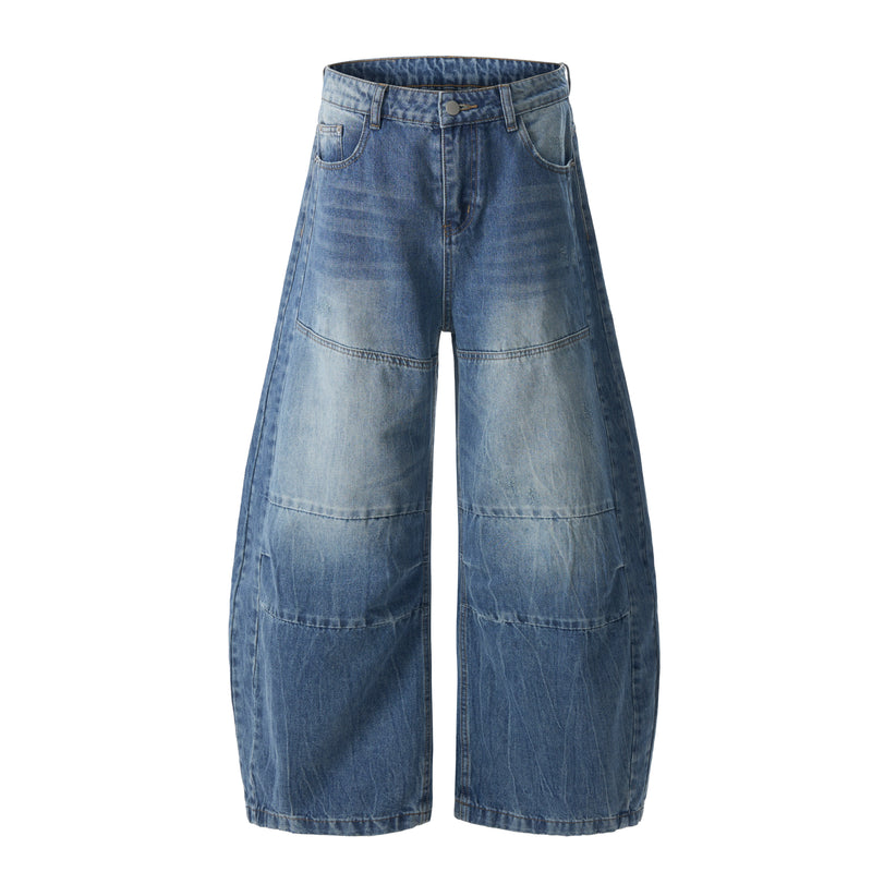 Front view of wide leg barrel jeans in faded blue denim with multi-panel seams