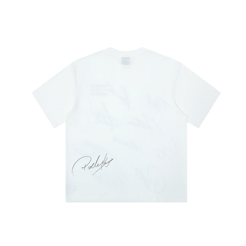 White oversized graphic tee with a black autograph-style signature print on the lower front