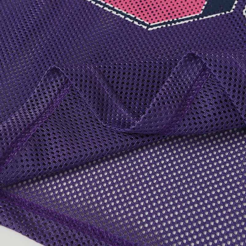 Close-up of a purple mesh varsity football jersey with breathable fabric and pink number detailing