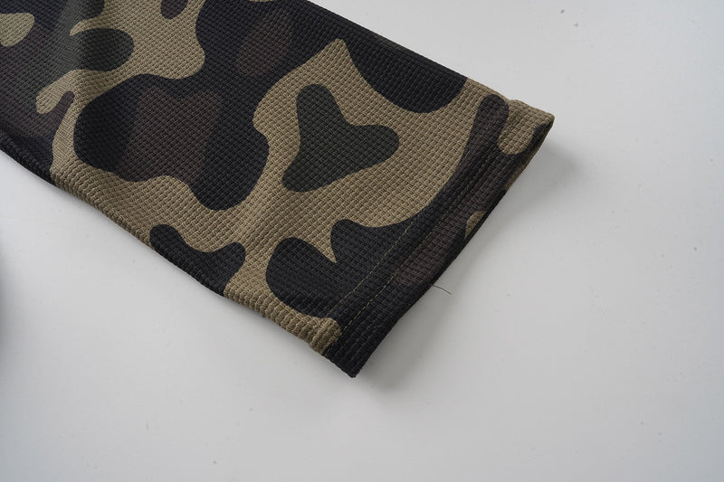 Folded camo jersey sleeve cuff with black and tan camouflage pattern
