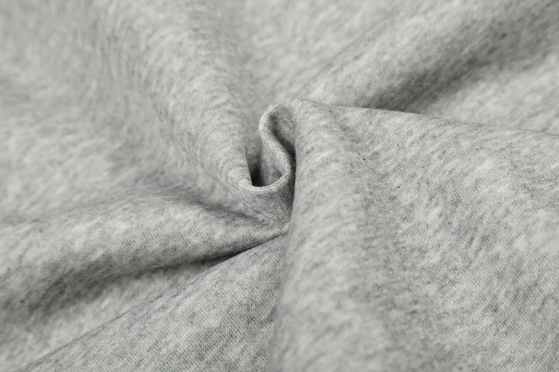 Close-up of light gray hoodie fabric texture with soft folds