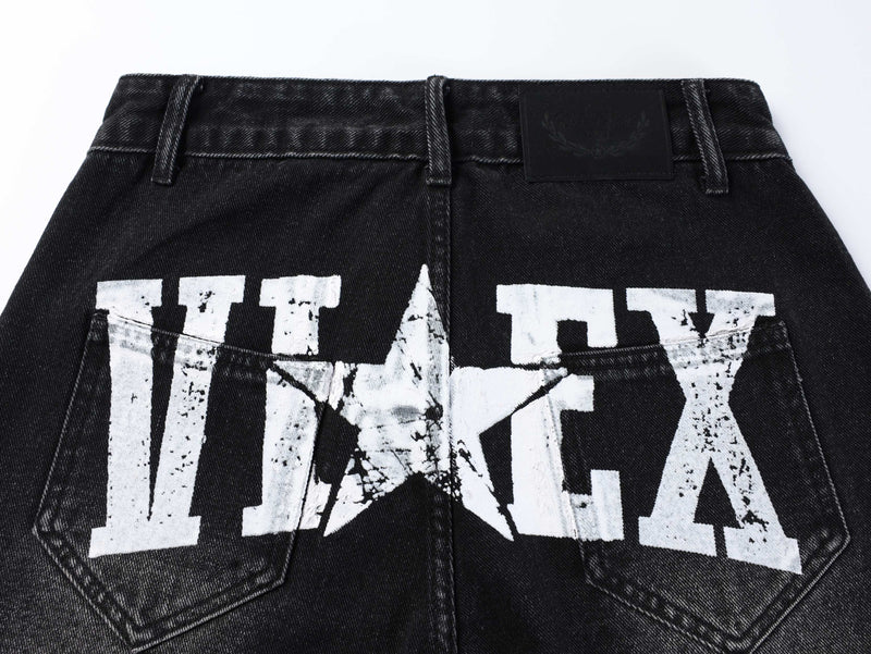 Back view of black wide-leg jeans with white distressed lettering and rear pockets