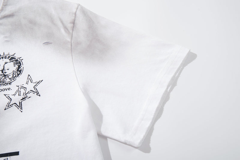 White oversized T-shirt with distressed black graphic collage and star print, shown in close-up on the sleeve and chest