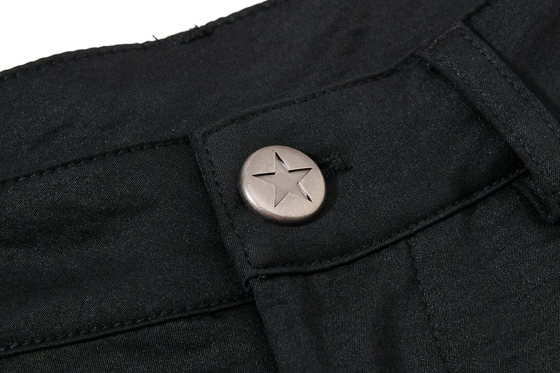 Close-up of black waistband button with star cutout on black fabric