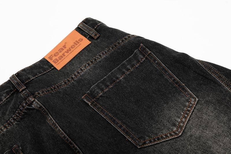 Back waistband and rear pocket detail on black vintage wash denim