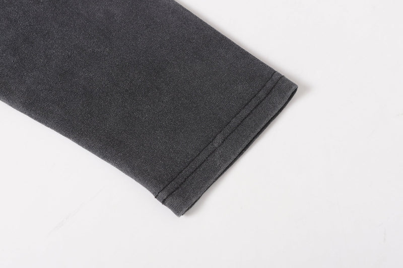 Folded black long sleeve tee sleeve hem with stitched cuff detail