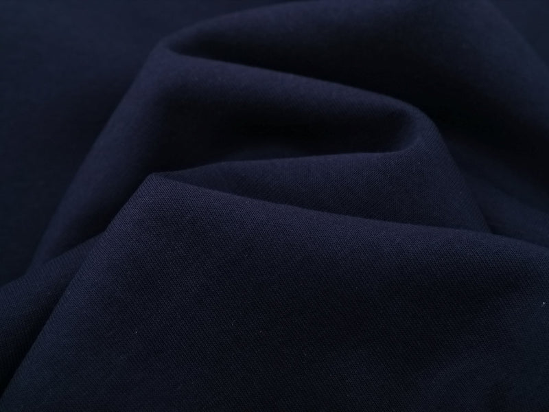 Close-up of navy sweatshirt fabric with soft knit texture