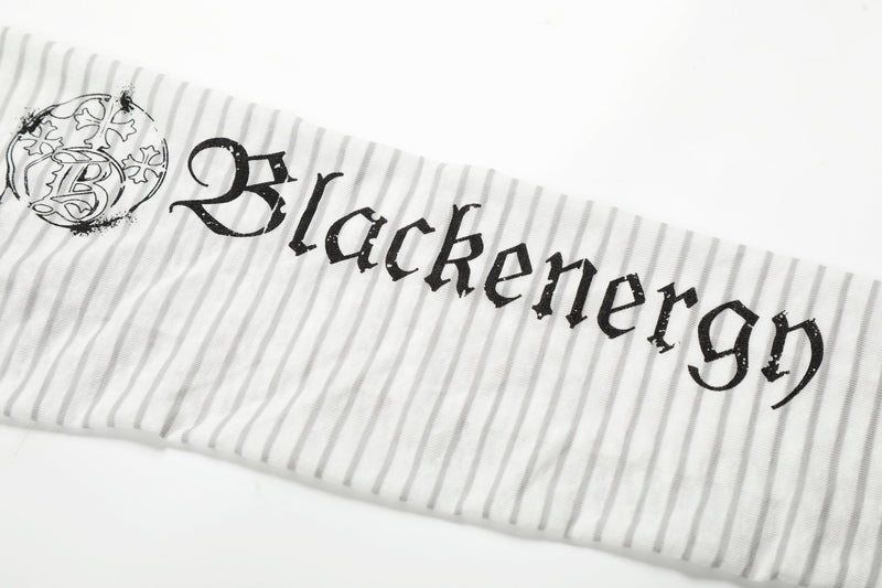 Close-up of sleeve graphic on white striped hoodie tee with gothic text