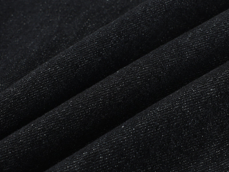 Close-up of black denim fabric texture with visible weave