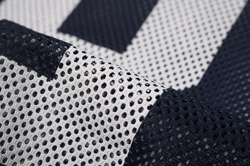 Close-up of navy and white perforated mesh jersey fabric with oversized varsity-style pattern and textured streetwear detail