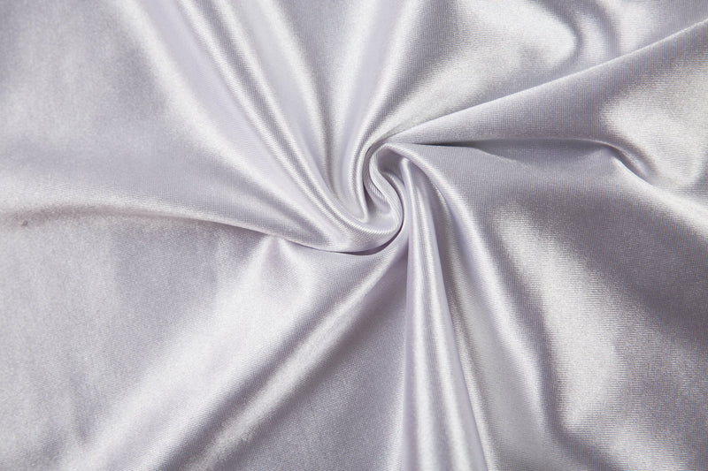 Close-up of shiny white jersey fabric gathered into a swirl