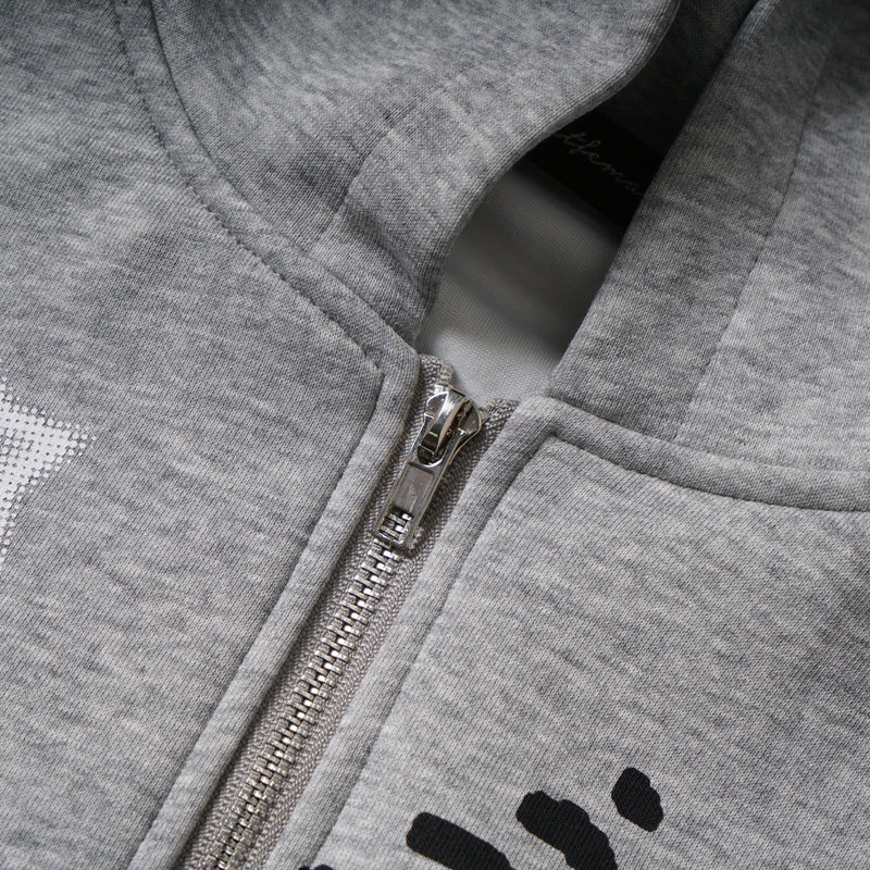Close-up of the front zipper and printed graphic on gray hoodie fabric