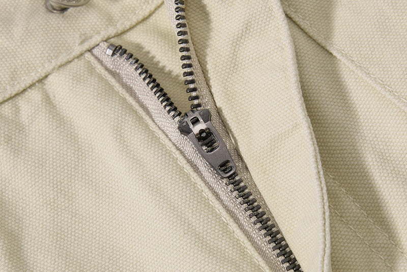 Close-up of beige cargo pants zipper and front seam stitching
