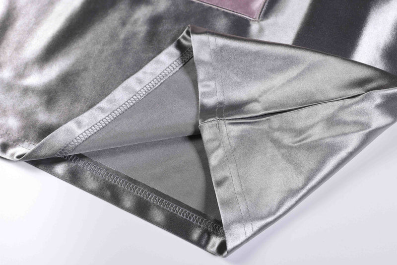 Close-up of a metallic silver varsity jersey tee hem with visible stitching and satin sheen