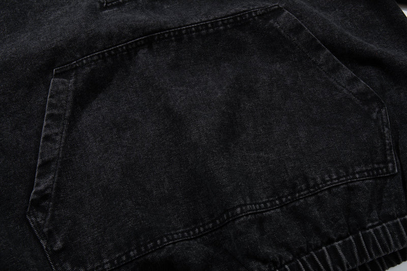 Close-up of kangaroo pocket on black washed denim hoodie