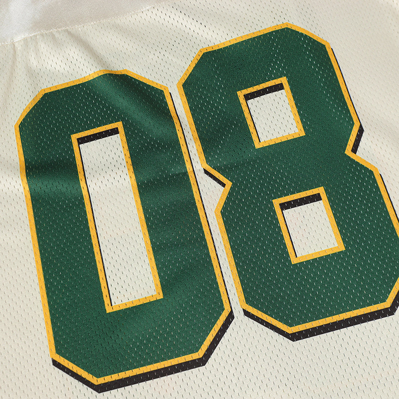 Close-up of a white mesh varsity jersey with large green number 08 outlined in yellow and black accents