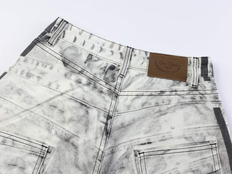Close-up of back waistband with brown logo patch and faded striped denim