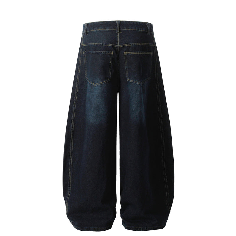 Back view of dark wash barrel denim pants with patch pockets and wide legs