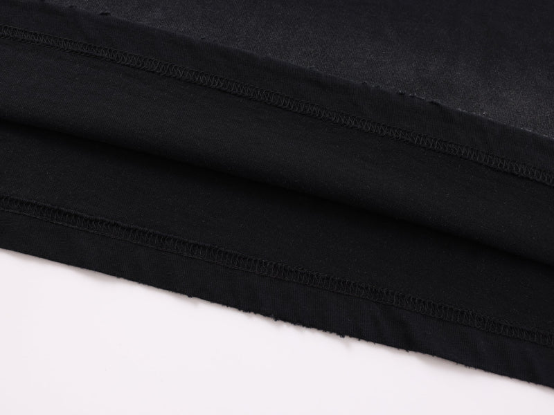 Close-up of black sleeve seam stitching on long-sleeve tee