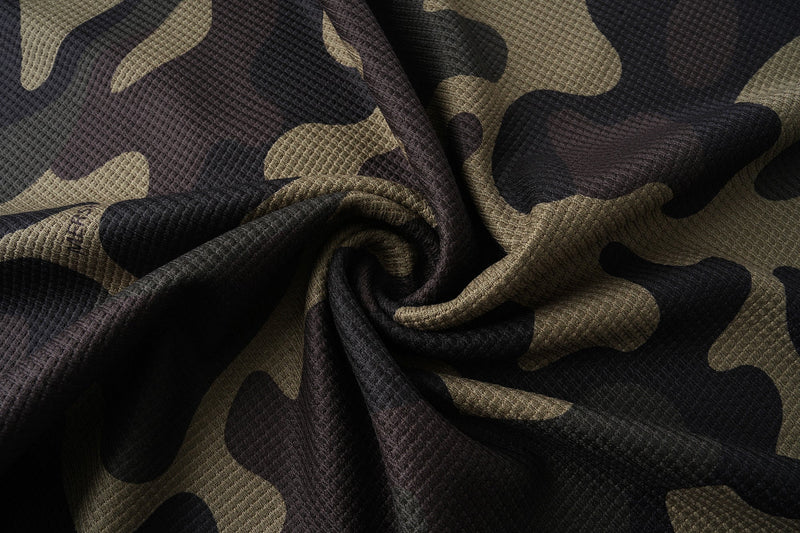 Scrunched camo jersey fabric showing textured waffle knit and black tan pattern