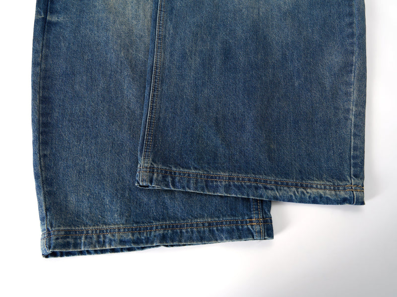 Close-up of hem and side seam on blue wide-leg jeans