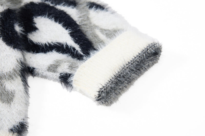 Close-up of black and white faux-fur hoodie sleeve cuff and shaggy trim