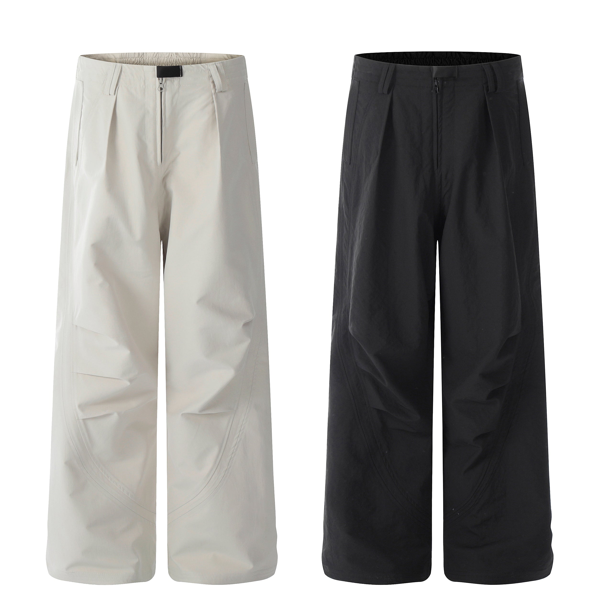 Omirad Tech-Sculpt Wide-Leg Pants in off-white and black, showing curved 3D panel lines, front pleats, and zip closure on whi