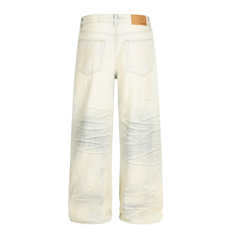 Back view of cream wide-leg jeans with five pockets and faded wash