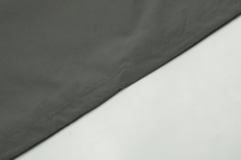 Close-up of smooth dark gray windbreaker fabric panel