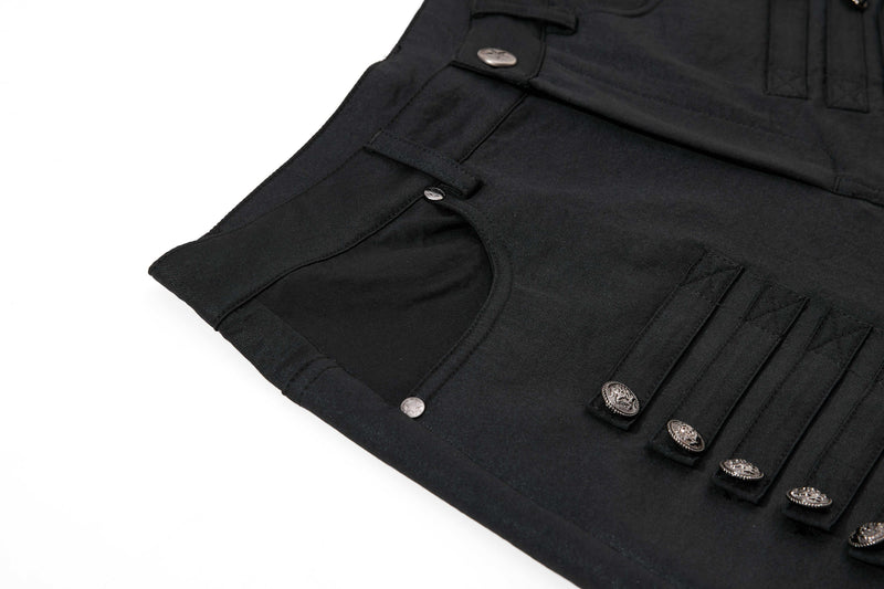 Close-up of black pants front pocket area with layered flap detailing and metal buttons