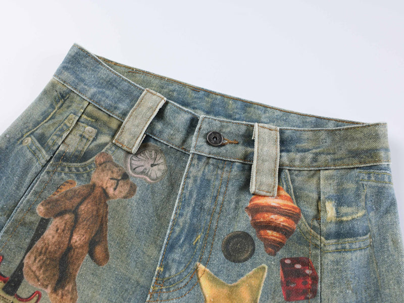 Close-up of the waistband with belt loops, button closure, and printed denim detail