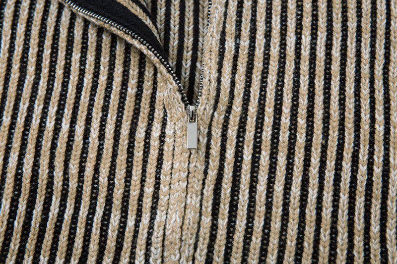 Close-up of the partially open front zipper on the striped ribbed knit jacket