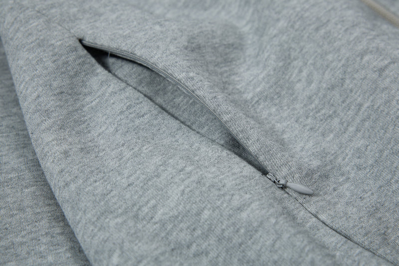 Close-up of side pocket zipper on gray hoodie