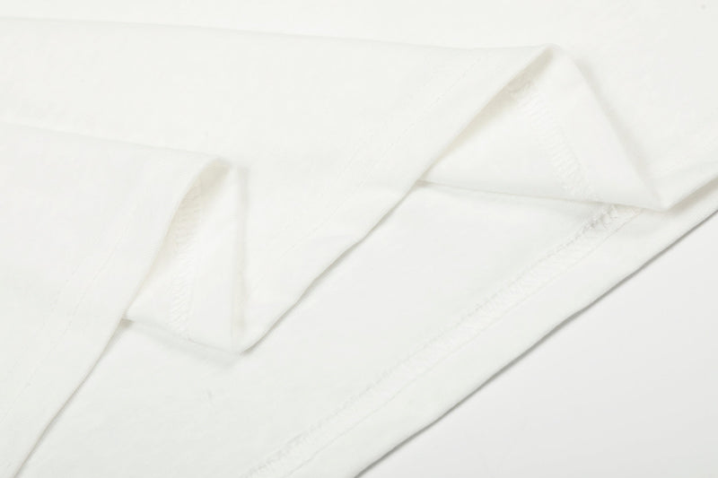 Close-up of white tee shoulder and sleeve seam