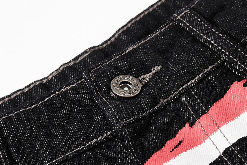 Close-up of metal button and top front waistband on black denim jeans