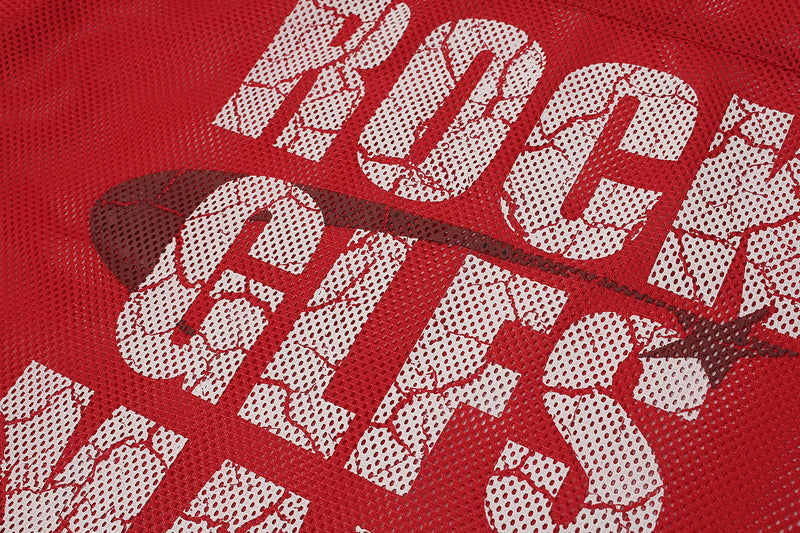 Close-up of a red oversized mesh football jersey with cracked white graphic lettering and a black Nike swoosh detail