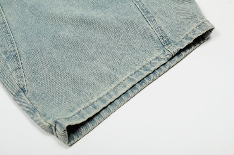 Close-up of hem on light wash denim wide leg jeans