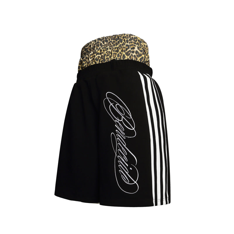 Side view of black shorts showing leopard waistband, white side stripes, and script print